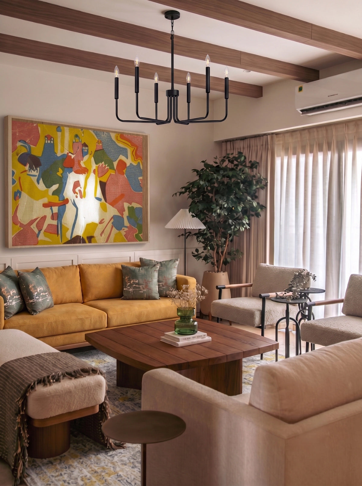 A modern living room featuring a large abstract painting with vibrant yellow, red, blue, and green colors on the wall above a mustard yellow sofa. The room is styled with a wooden coffee table, beige armchairs, a black multi-light chandelier, and a potted plant.