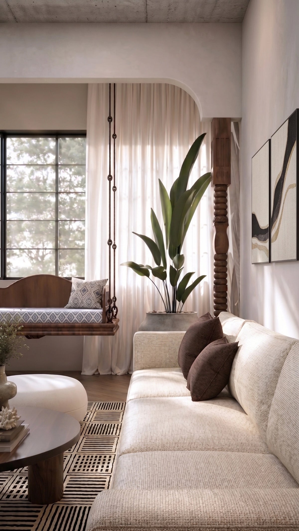 A modern living room featuring a textured cream sofa with dark brown accent pillows, a woven black and beige rug, a round wooden coffee table, and a large potted green plant in a bright, sunlit space with an arched doorway and window.