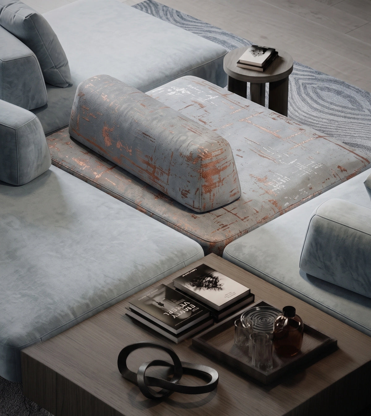 A modern modular sectional sofa in light blue-gray velvet, styled in a contemporary living room with a distressed orange-brown accent rug, a matching cylindrical lumbar pillow, a small round side table, and a wooden coffee table in the foreground.