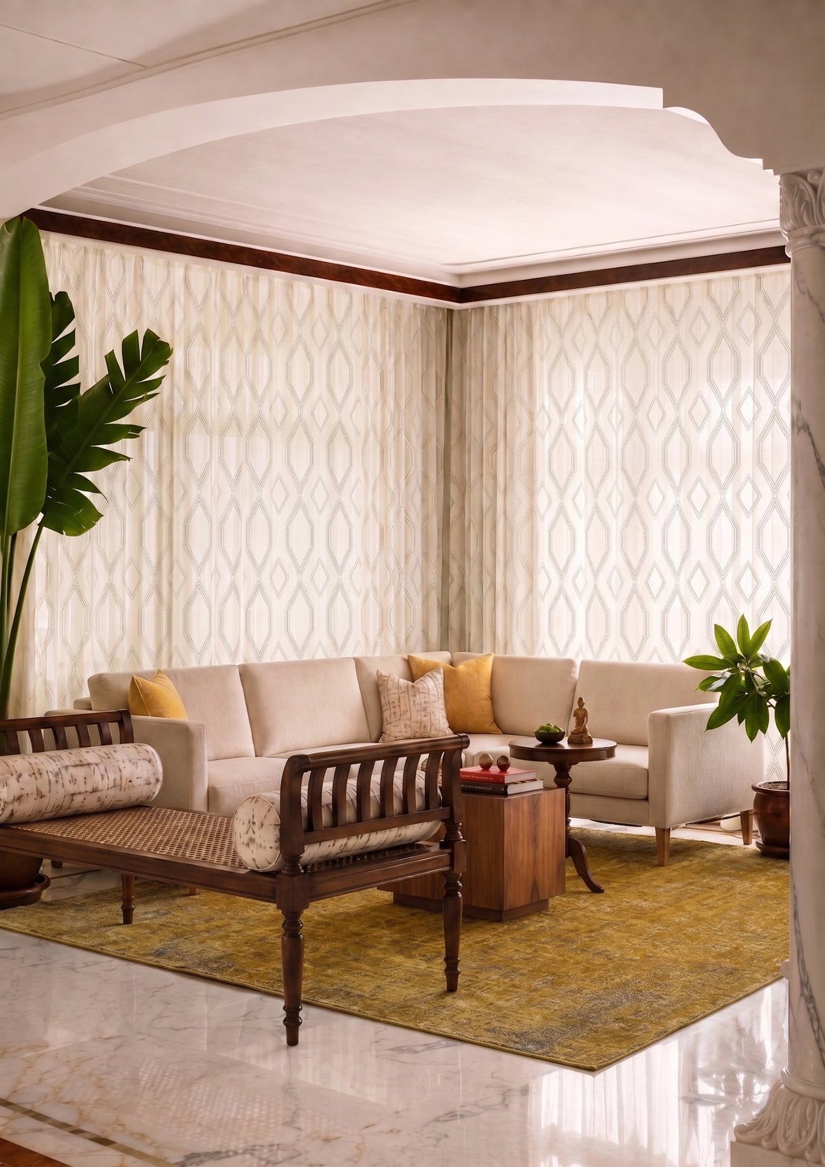 A styled interior room with cream patterned wallpaper, a beige sofa with yellow pillows, a dark wood bench, a yellow rug, and potted plants.